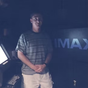 a photo of Michael in front of IMAX sign