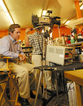 a photo of two men working to shoot a scene